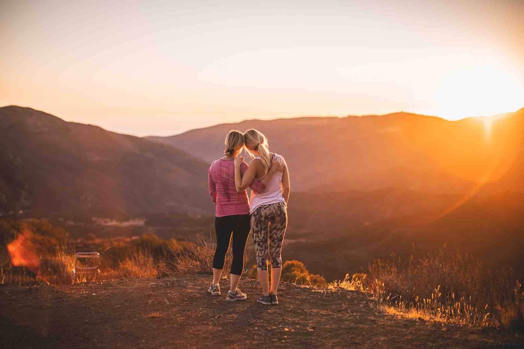 Two women looking at a sunset. 