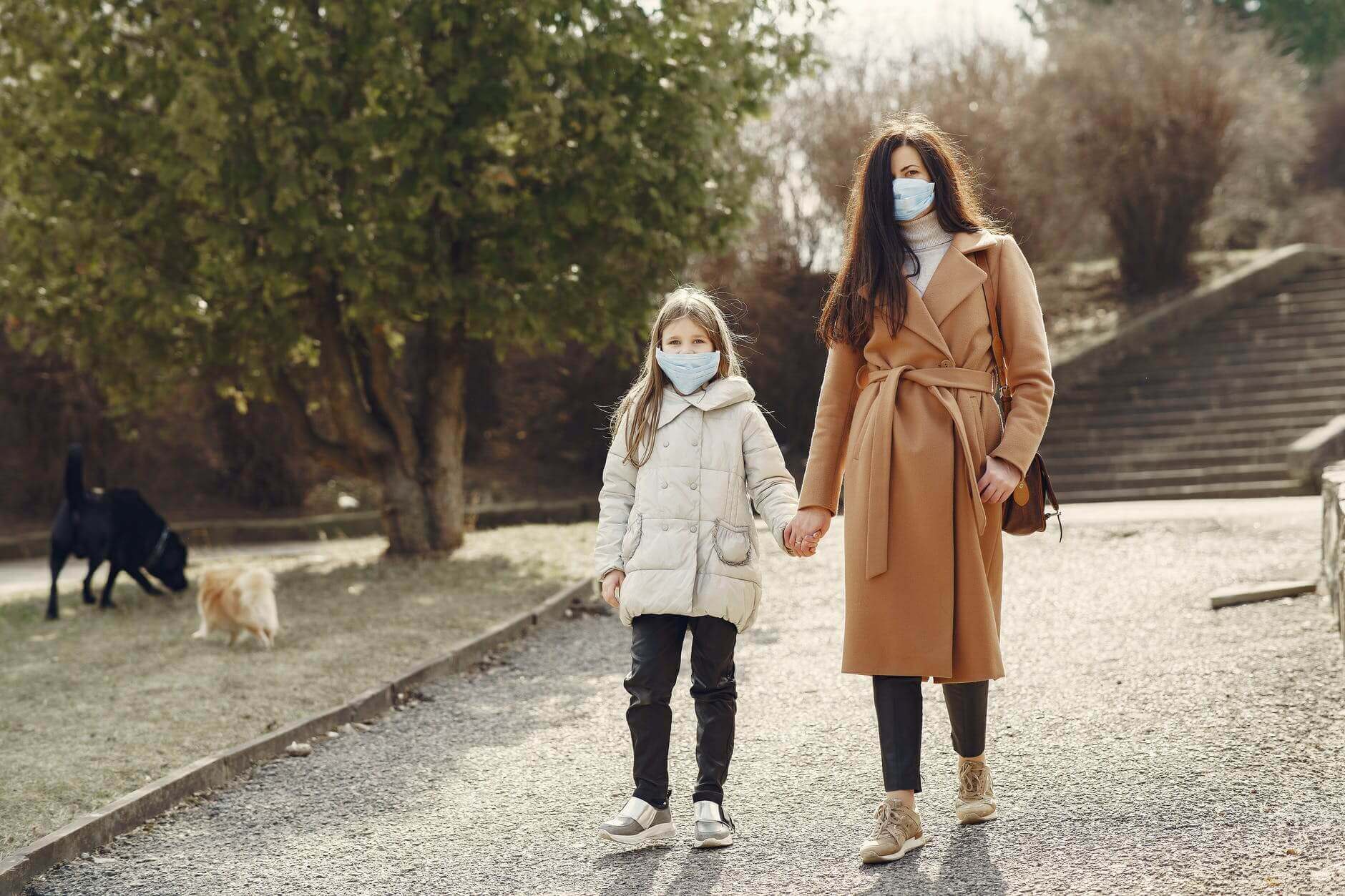 An image of a woman and her daughter walking.