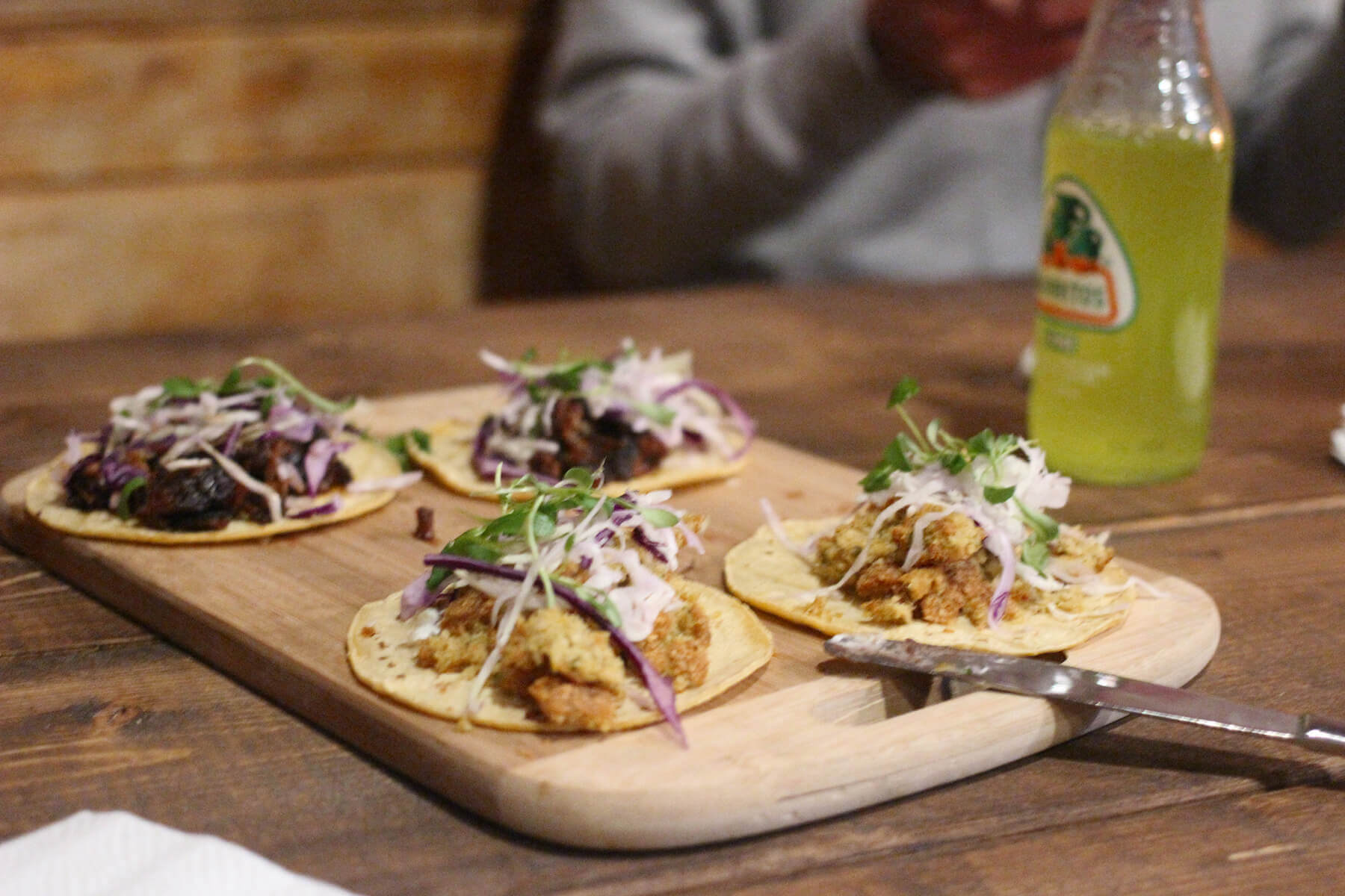 A dining table with tacos