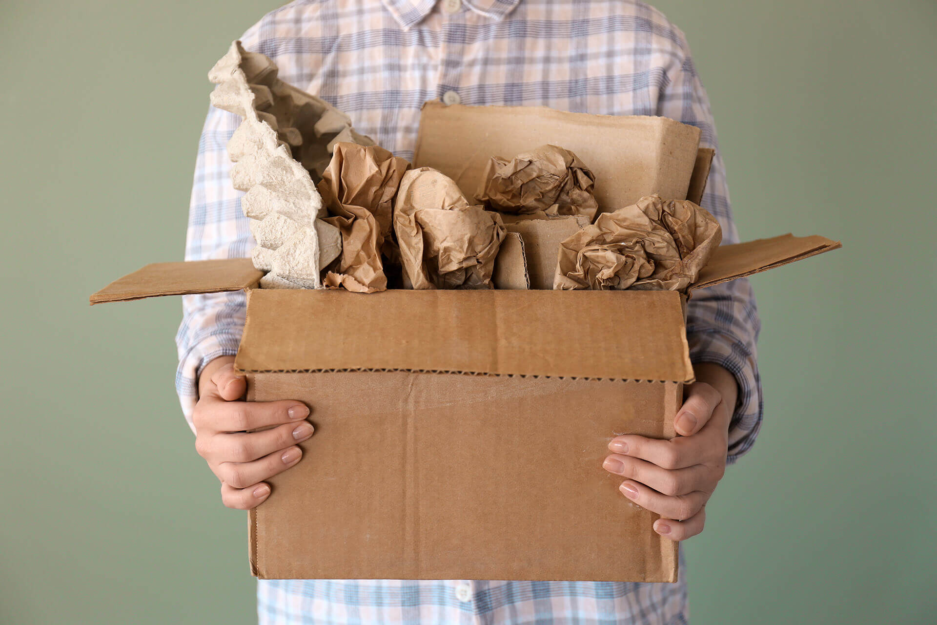 A man holding a box with materials