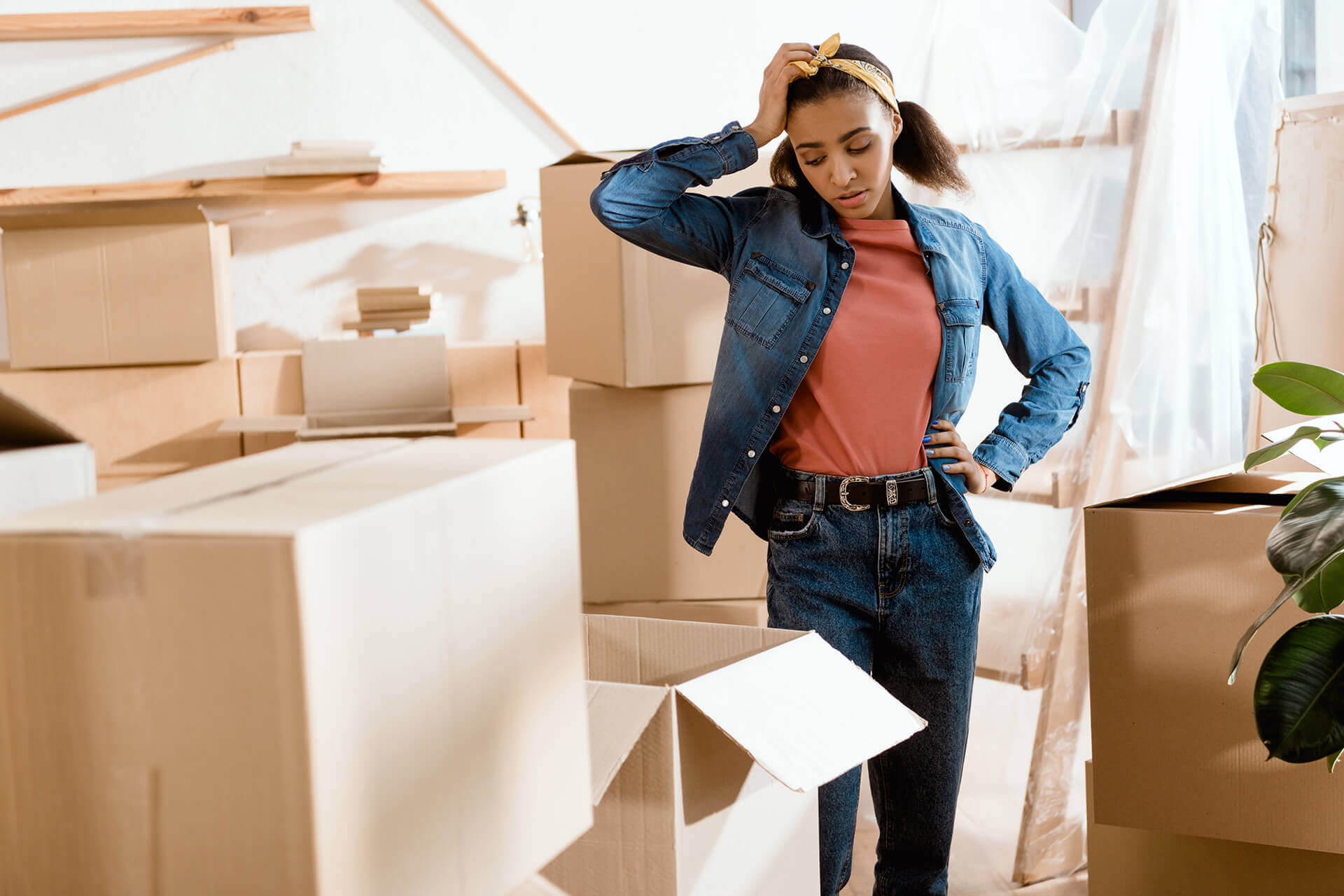Girl with boxes worried about moving out for the first time without the help of Los Angeles movers