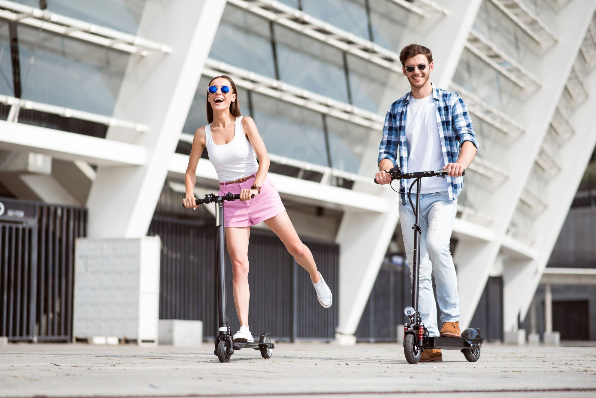 A couple riding electric scooters