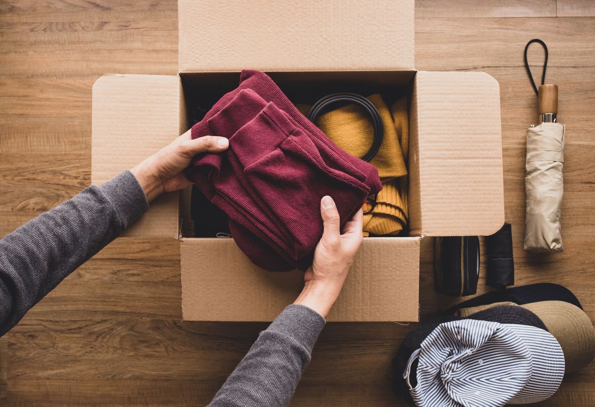 Man placing a sweater in the package