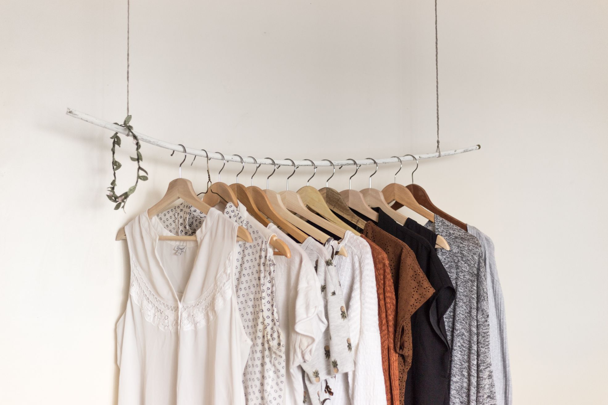 Rack of clothes in front of a white wall