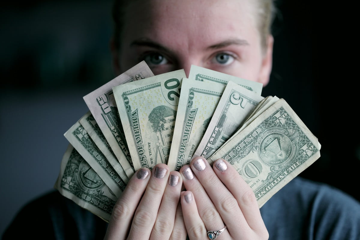 A girl holding cash