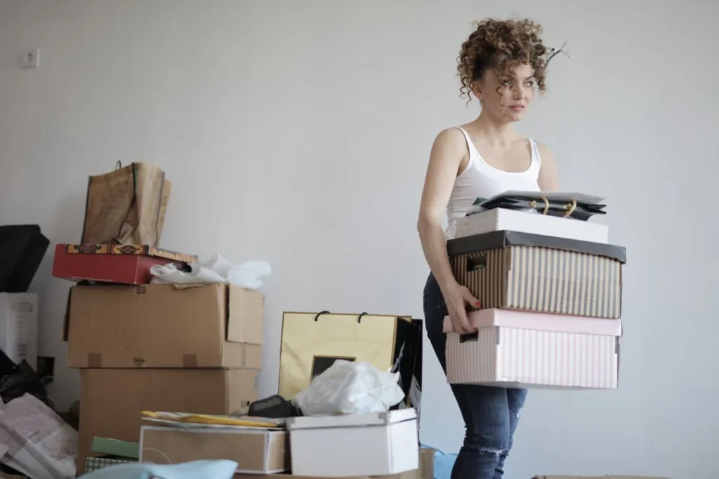 a girl carrying boxes 