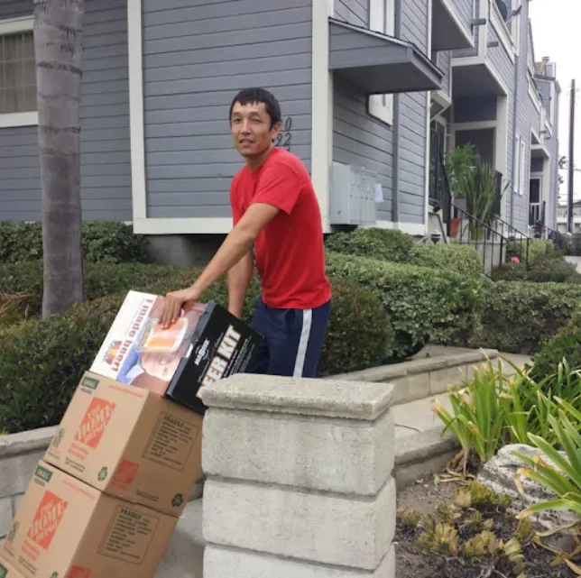 Movers moving a trolley with boxes